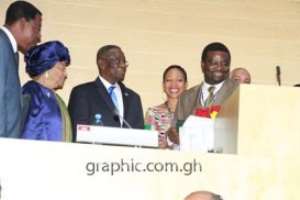 Prof Oluwode Daniels Makinde R of Cape Peninsula University expressing appreciation after receiving the award from President Mills M. Looking on are President Yaya Boni of Benin L and President Johnson Sirleaf of Liberia and Ms Samia Nkrumah