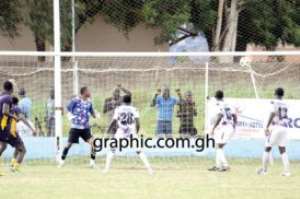Medeama's Louis Agyeman (2-L) scores the second goal for his side while Liberty's Daniel Adjei and some fo his teammates look on