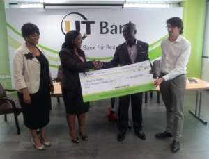 Ghanas Jonnie Walker, Prince Kofi Amoabeng (second from right) presents the cheque to Country Manager of Enablis Ghana, Sika Acolatse while Alan McLeneen (far right), and Pearl Essuah-Mensah (Deputy MD of UT Bank) look on