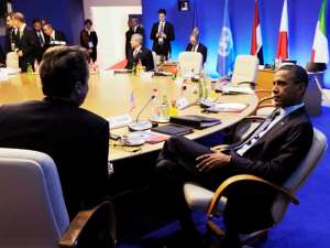Britains Prime Minister David Cameron (L) speaks with U.S. President Barack Obama during a round table meeting at the G8 summit.