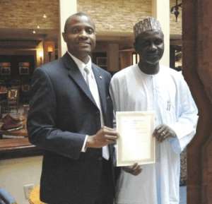 L-R Afripols Emeka  Chiakwelu   presenting the award to His Excellency Malam Dr. Ibrahim Shekarau