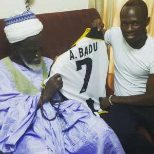 Ghana midfielder Emmanuel Agyemang-Badu with the Ghanaian chief Imam
