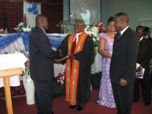 REVEREND FRENCH RECEIVING A CITATION IN HONOUR OF HIS SERVICE.