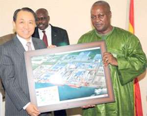 Flashback: Kang Duk-soo, Chairman of STX Group presents an artist's impression of the proposed houses to Vice President Mahama. Behind them is B.K. Asamoah