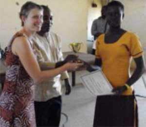 Gadaf M. Rahinath Zibango, right a student of Sapeliga JHS, receiving a trophy and a certificate from Ms Jillian Hess, Human Rights Advisor for Bongo.