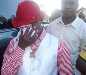 Rev Ebenezer wiping away tears at the prisons