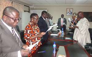 Energy Minister at head of table swearing in the reconstituted board