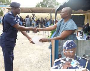 A hardwarking officer recieving his award.INSET: DCOP Ninso