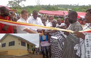 Top dignitaries cutting tape to open the project. INSET: The health facility