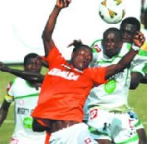 Edubiase midfielder Baba Gullit (2nd left) in a fierce tussle for the ball with Jets striker Aaron Amoah (2nd right).