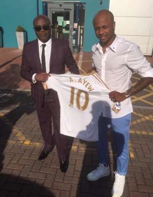 Ghana winger Dede Ayew with father Abedi Pele minutes after signing the deal