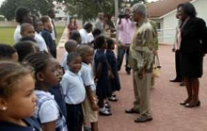 Mr Kofi Annan 2nd right interacting with schoolchildren of Association International School during the visit.  Those with him are Mrs Audrey Amoah Doryumu right, Head of the school and Mrs Nane Annan 3rd right.