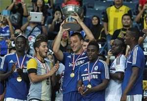 Winners: John Terry lifts the trophy after Chelsea8217;s 4-1 victory against an Malaysia XI at the Shah Alam Stadium