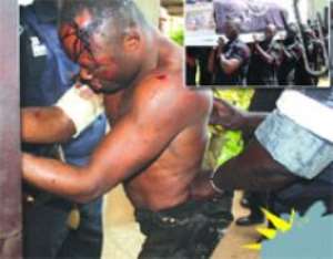 Kombian when he was brought to the Police Headquarters in Accra yesterday. INSET:  The casket containing the remains of Constable Prince Kwaku Agyare being carried from the Old Tafo Presbyterian Church to be interred at the Old Tafo cemetery.