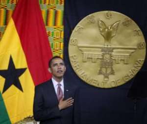 Obama listens to the national anthem before addressing the Ghanaian parliament at the Accra International Conference Centre  Photograph: Jim Young/Reuters