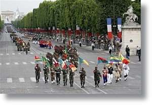 African troops hold flags during the annual Bastille Day military parade on The Champs Elysee Avenue in Paris. Photo courtes