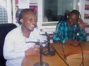 Evans Mensah with a broad smile in front with Bernard Saibu looking on in admiration.