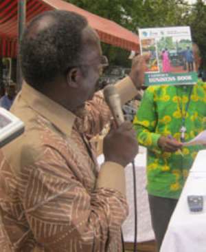 The Minister of Food and Agriculture, Mr. Kwesi Ahwoi, launching the Farmer039;s Business Book at Sandema