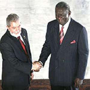 President Kufuor right in a handshake with the Brazilian President