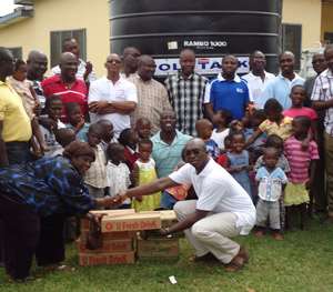 A member of  the club presenting the items. With him are other members and inmates of the home