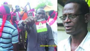 Some of the defectors showing their NDC party cards (left),  Dr. Kwabena Adjei €“NDC National Chairman(right)