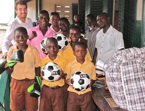 Commey wiith the pupil and officials of Odartey Lamptey JHS