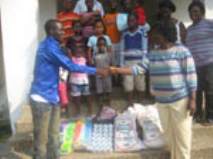 Mr. Akrofi presenting the items to the mother of the house