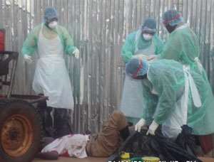 Medical team dressed in Ebola apparel conveying the body