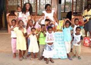 Miz Gold shows affection to orphans
