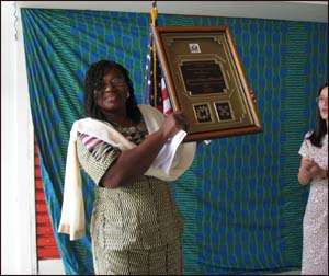 Mrs. Janet Adama Mohammed displaying her award