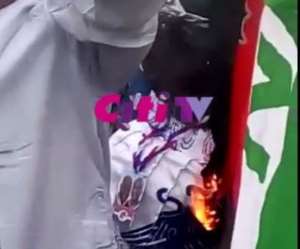 Disappointed NDC serial caller burns party flag Video