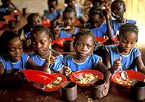 Pupils of a community school enjoying their meal courtesy the school feeding programme