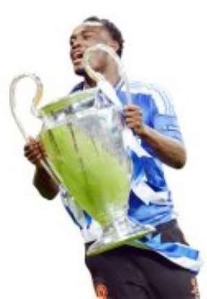 Michael Essien celebrates with the UEFA CL cup