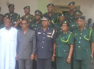 Interior Minister W K Aboah and COP Dr Peter A Wiredu, Acting Director of GIS middle, in a group photograph with executives of the GIS