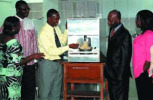 Mr John Abban 3rd left, head of Engineering Department of the Koforidua Polytechnic, who assembled the machine, explaining a point on how the pounder operates to Prof. Reynolds Okai 2nd right, Rector of the polytechnic.