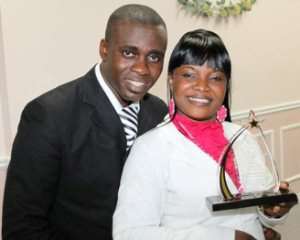 Ohemaa Mercy holding award with husband and manager, Isaac Twum-Ampofo.