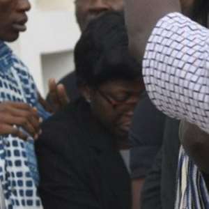 DSP Gifty Mawuenyega Tehoda in black being ushered to court