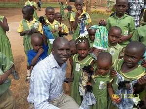 David Ssejinja and the children from his SC Foundation pose for a Group Photo