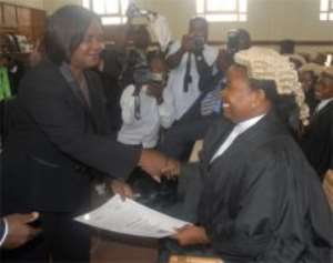 Chief Justice Wood presenting a certificate to Ms Esther Gyamfi, one of the new lawyers