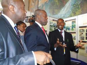 Vice President, Paa Kwesi Bekoe Amissah-Arthur, being briefed by Mr. Sylvester Segbaya, Director of the AngloGold Ashanti Malaria Control Programme on some of the malaria intervention projects undertaken by the company