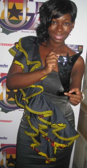 Presenter-Actress Ama K. Abebrese holding GUBA Award