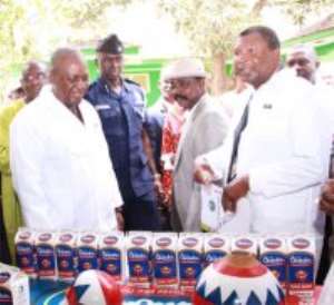 Vice  President Mahama inspecting some of the Chibuku drink with Dr Charles Mensah R, Board Chairman of Accra Brewery
