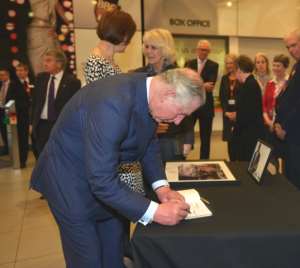 Photo: Prince of Wales signs Komla Dumor's book of condolence