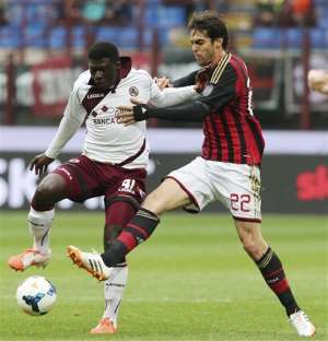 AC Milan Brazilian forward Kaka, right, challenges for the ball with Livorno midfielder Joseph Duncan, of Ghana, during the Serie A soccer match between AC Milan and Livorno at the San Siro stadium in Milan, Italy, Saturday, April 19, 2014.