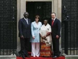 Britain's Prime Minister Tony Blair R and his wife Cherie 2nd L pose with Republic of Ghana President John Agyekum Kufuor L and his wife Theresa 2nd R outside 10 Downing Street in London March 14, 2007