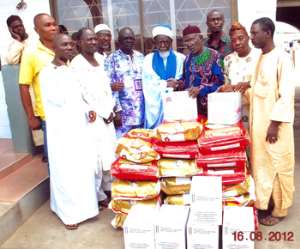 Sheikh Nuhu Sharubutu (Middle) receiving the items donated by Nana Akufo-Addo