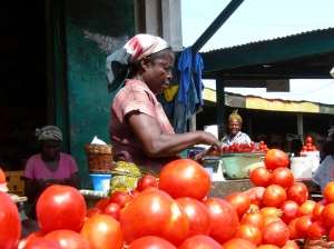 A Woman manages her product at a market in Accra, Ghana