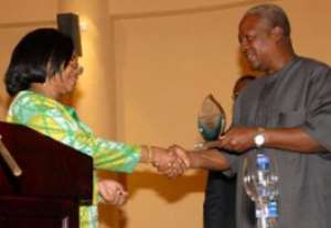 Vice-President Mahama being presented with a shield by Ms Lamptey, at the opening session of the 2011 National Conference on Intergrity