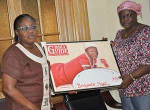 Mrs. Gina Blay receiving the painting from a representation of Kunata Voluntary Organisation