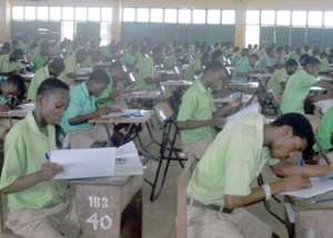 Student of St. John’s School writing the Core Mathematics paper on Tuesday with their sandals and slippers (above) outside the Exams hall